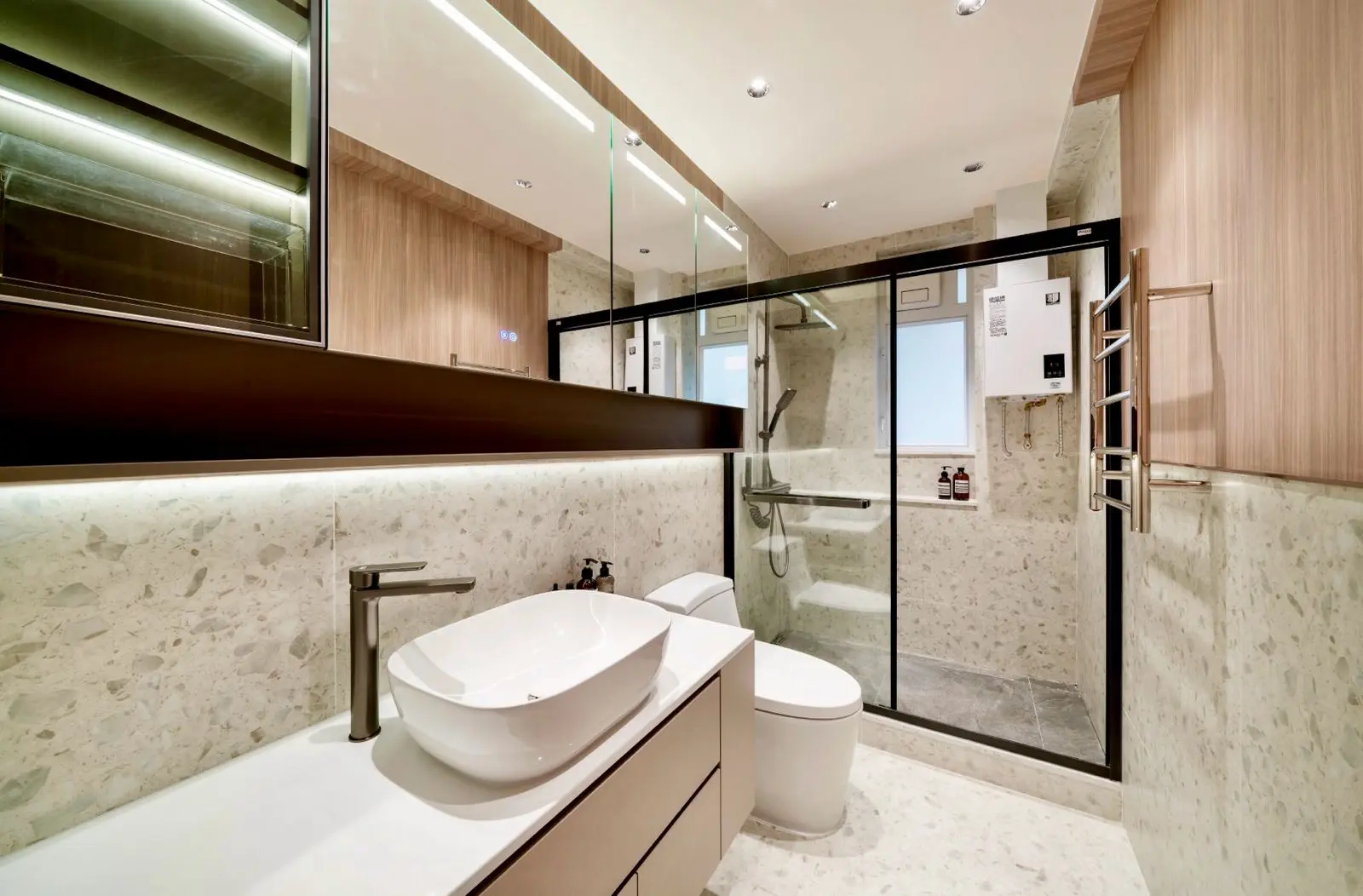 Stone-lined bathroom with timber vanity and glazed shower