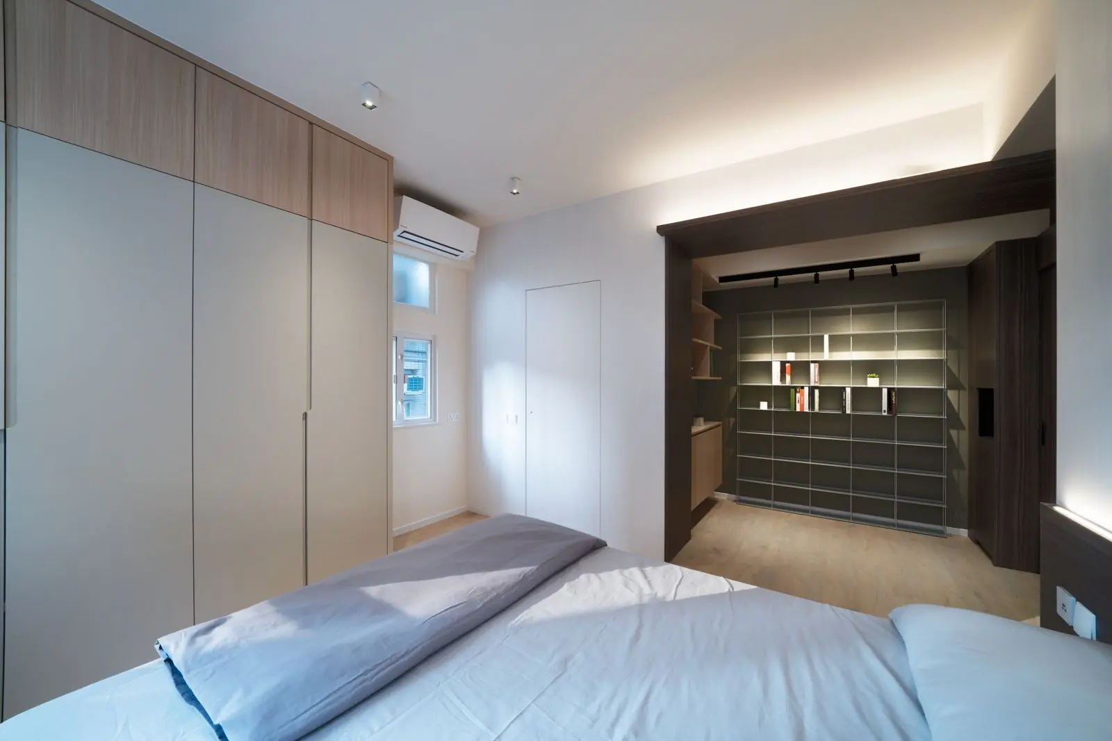 Bedroom with full-height wardrobes and open shelving