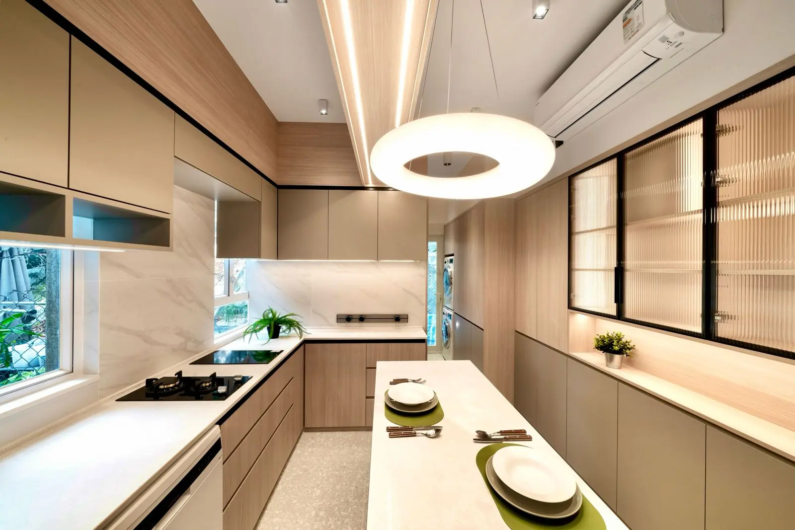 Expanded U-shaped kitchen with pale cabinetry and dark-framed glazing