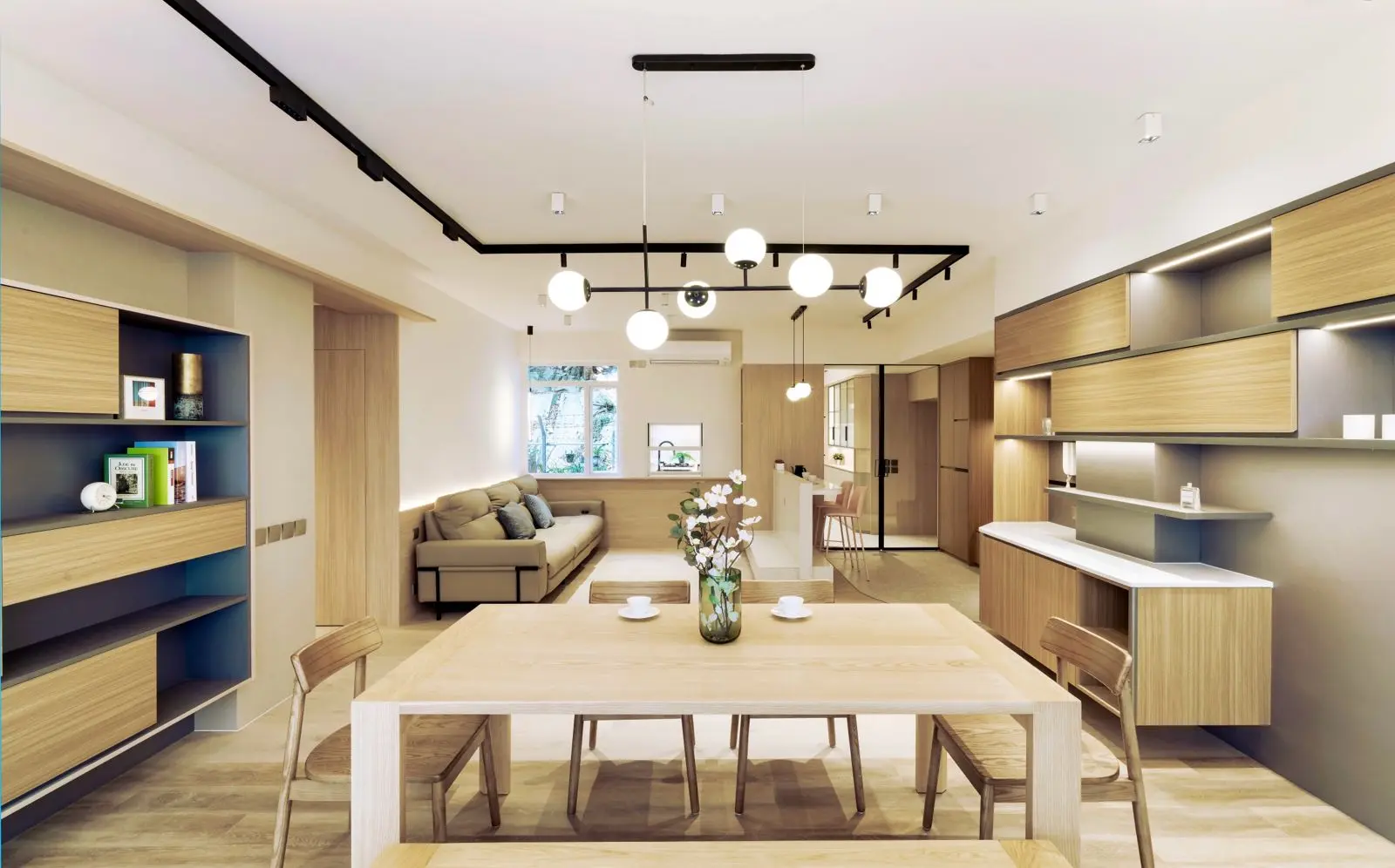 Long dining table aligned with the open living area and full-width windows