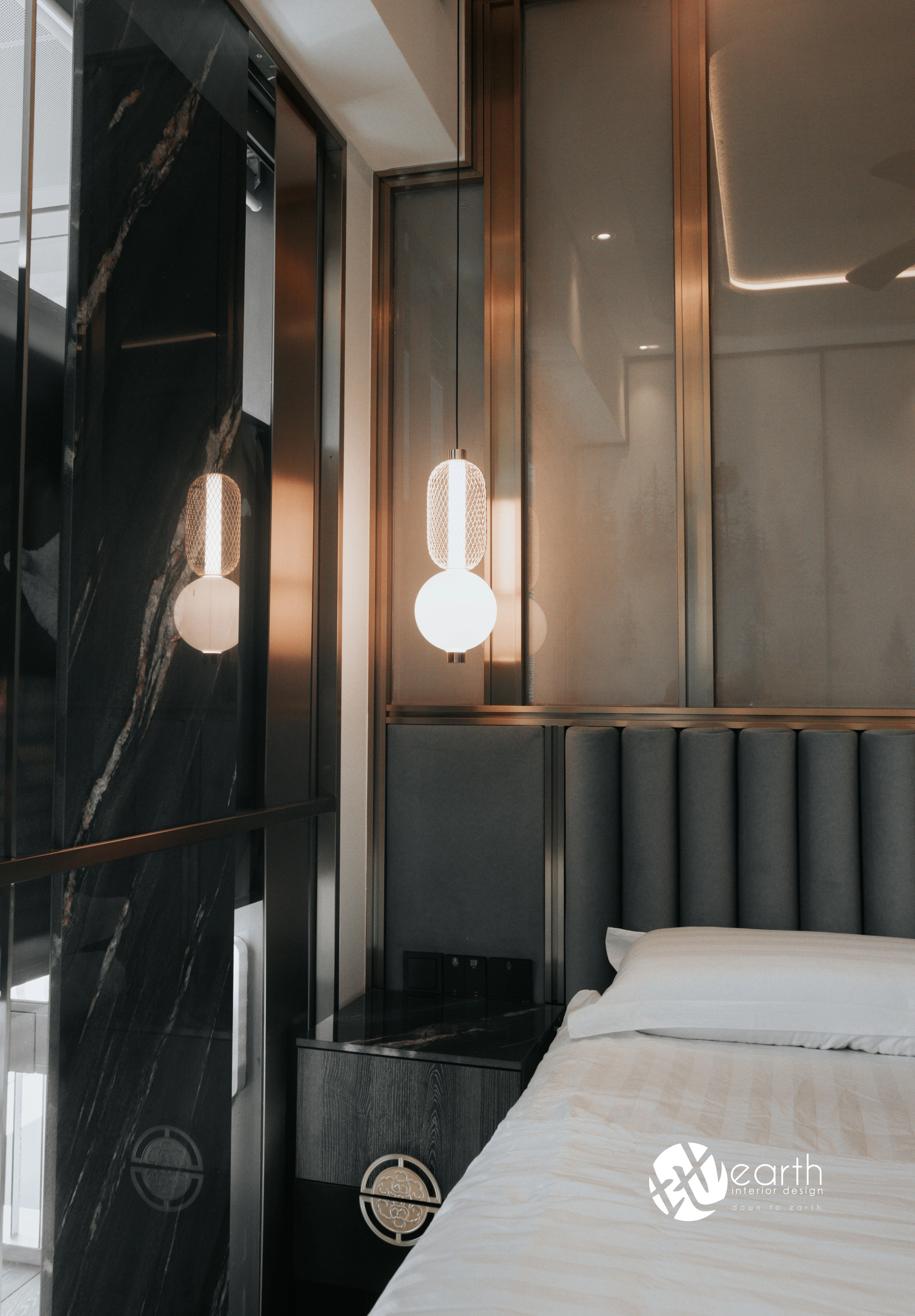 Bedside lighting and dark wall detailing at Harbour Lux