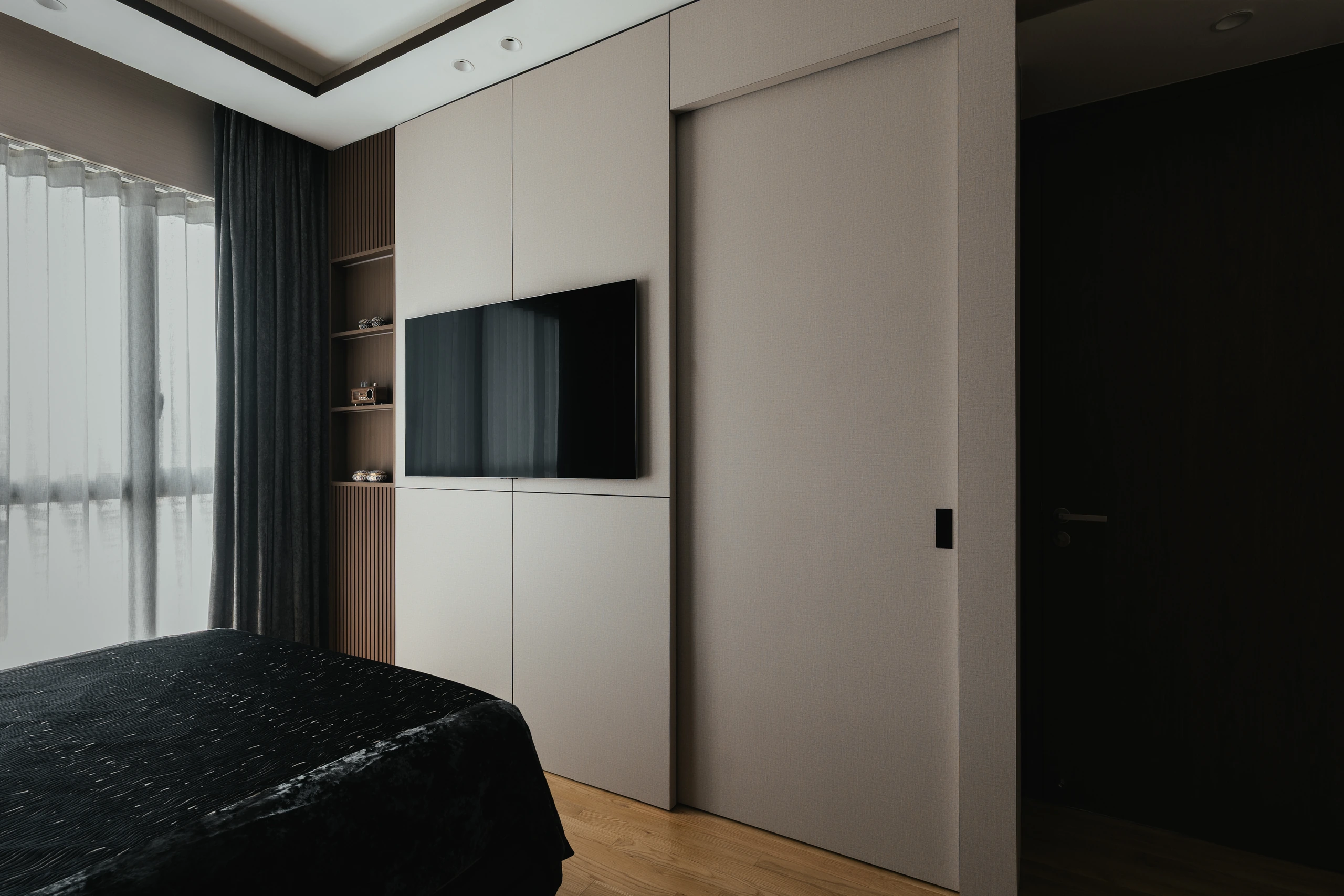 Master bedroom television wall with concealed passage by Edgeline Planners