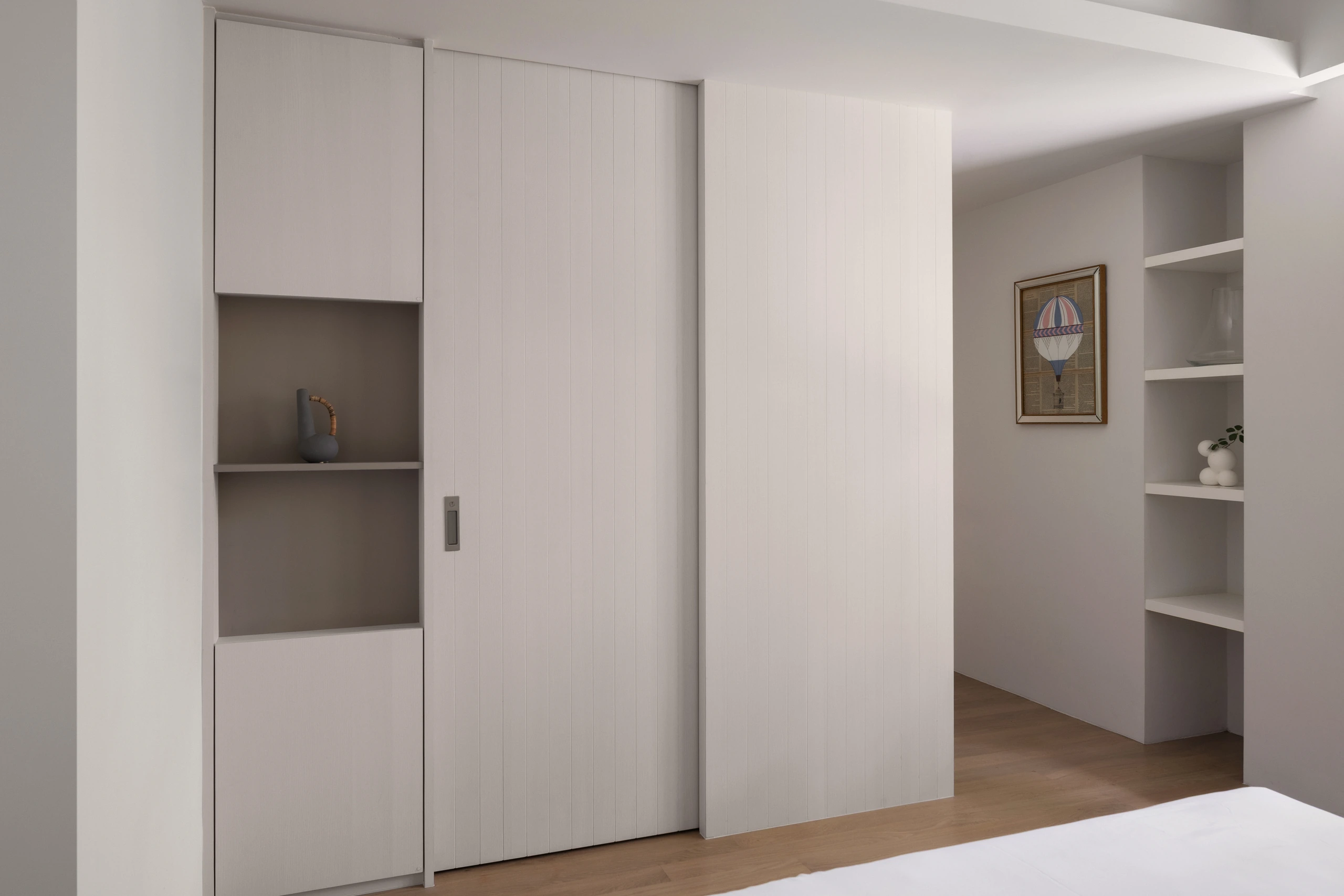 Common bedroom with concealed vanity and shelving by Edgeline Planners
