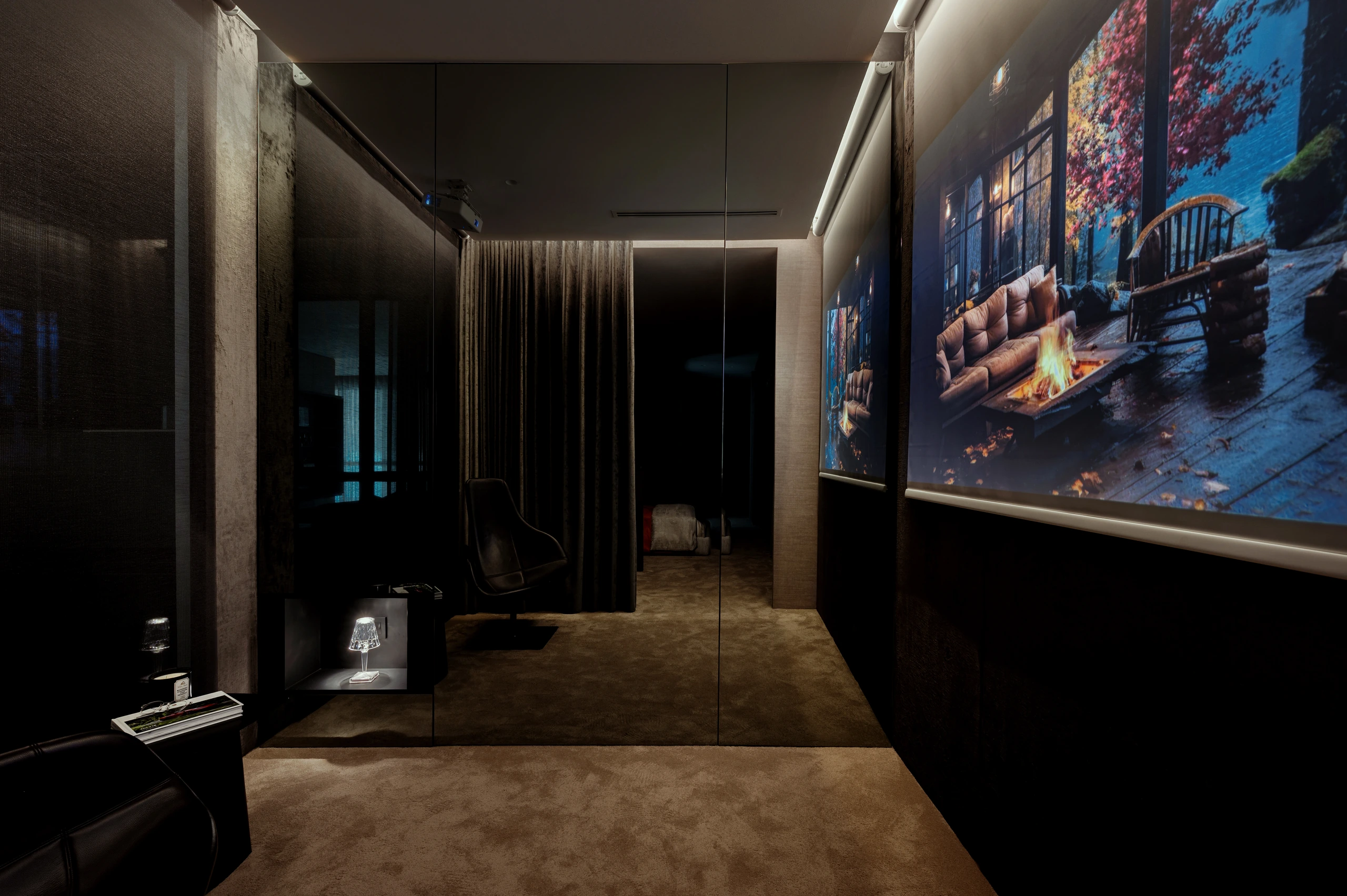 Dark private theatre with large projection screen by Edgeline Planners