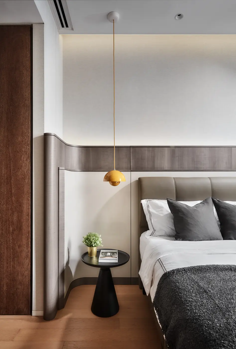 Master bedroom bedside — Flowerpot VP1 pendant above black side table with plant and book
