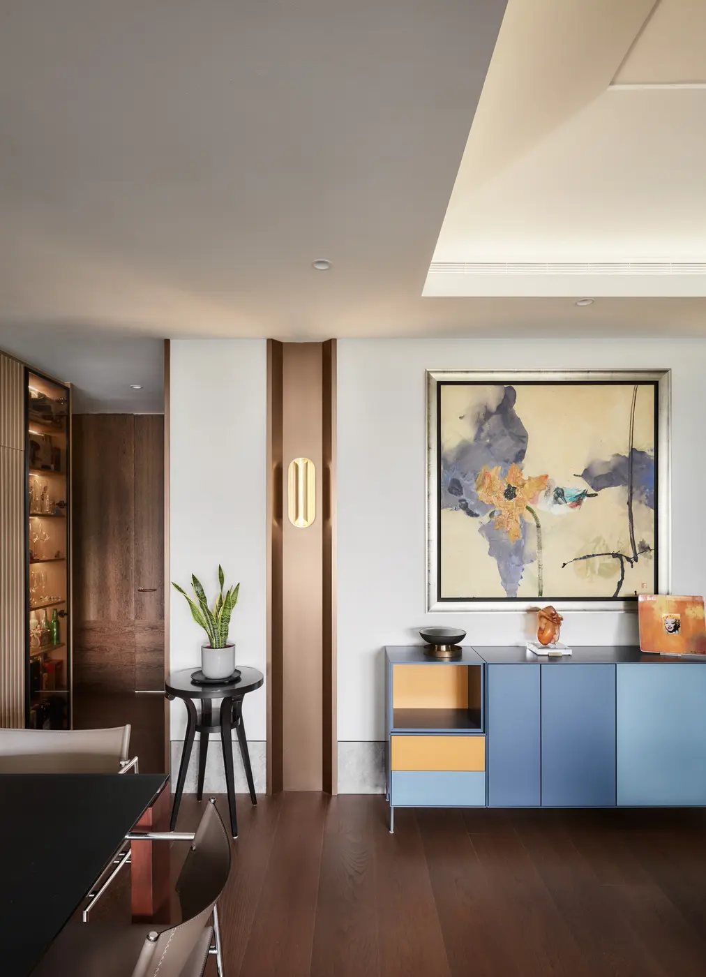 Bedroom detail with curved panel and brass side table