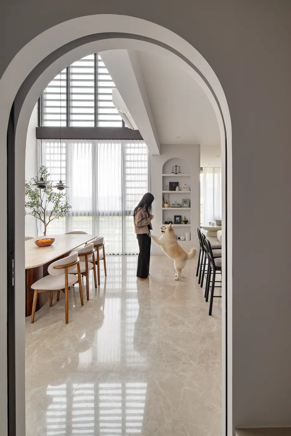 Arched doorway entry to the dining space with dog