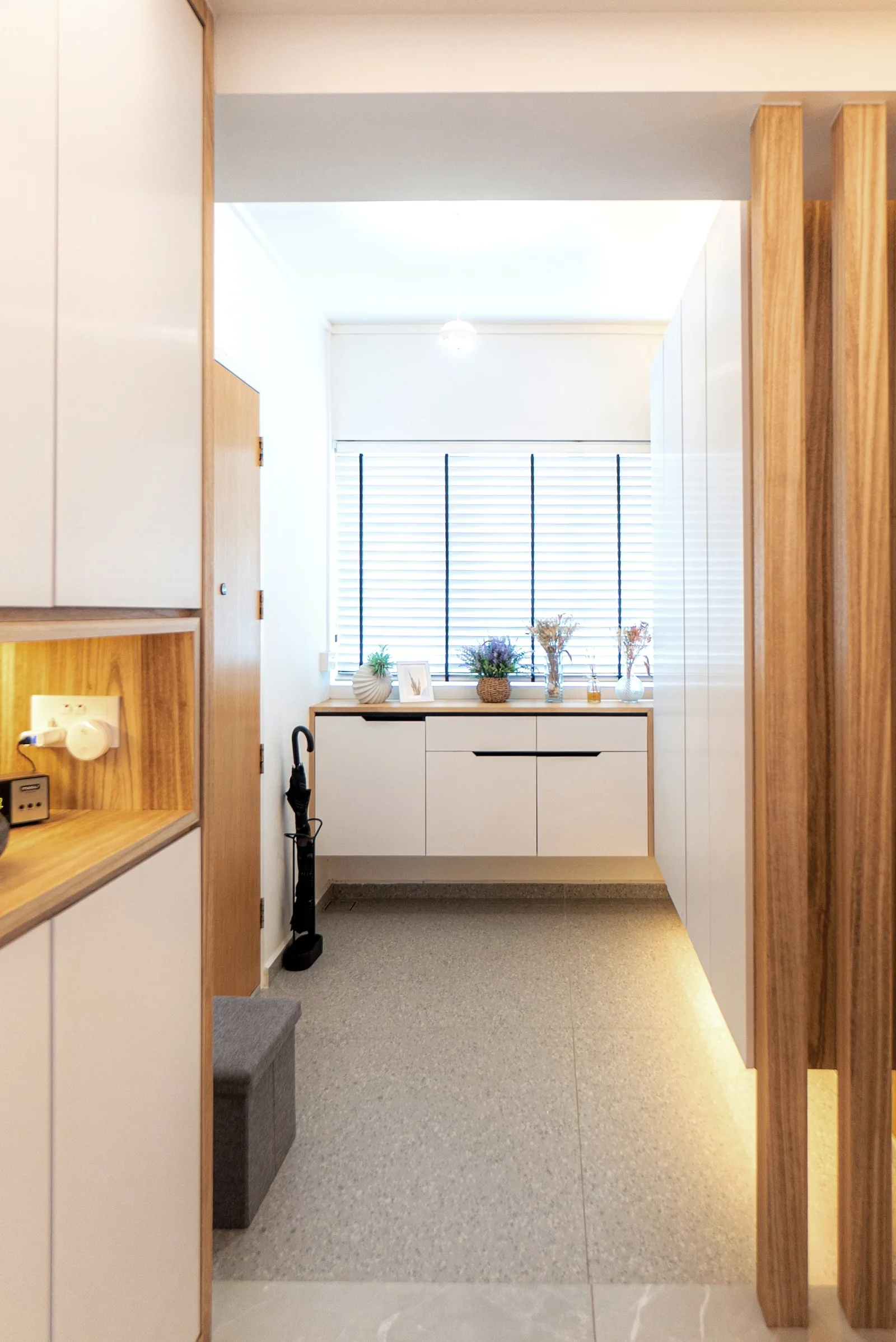 J Concept Designers &mdash; view through timber screen into foyer with shoe cabinet and window