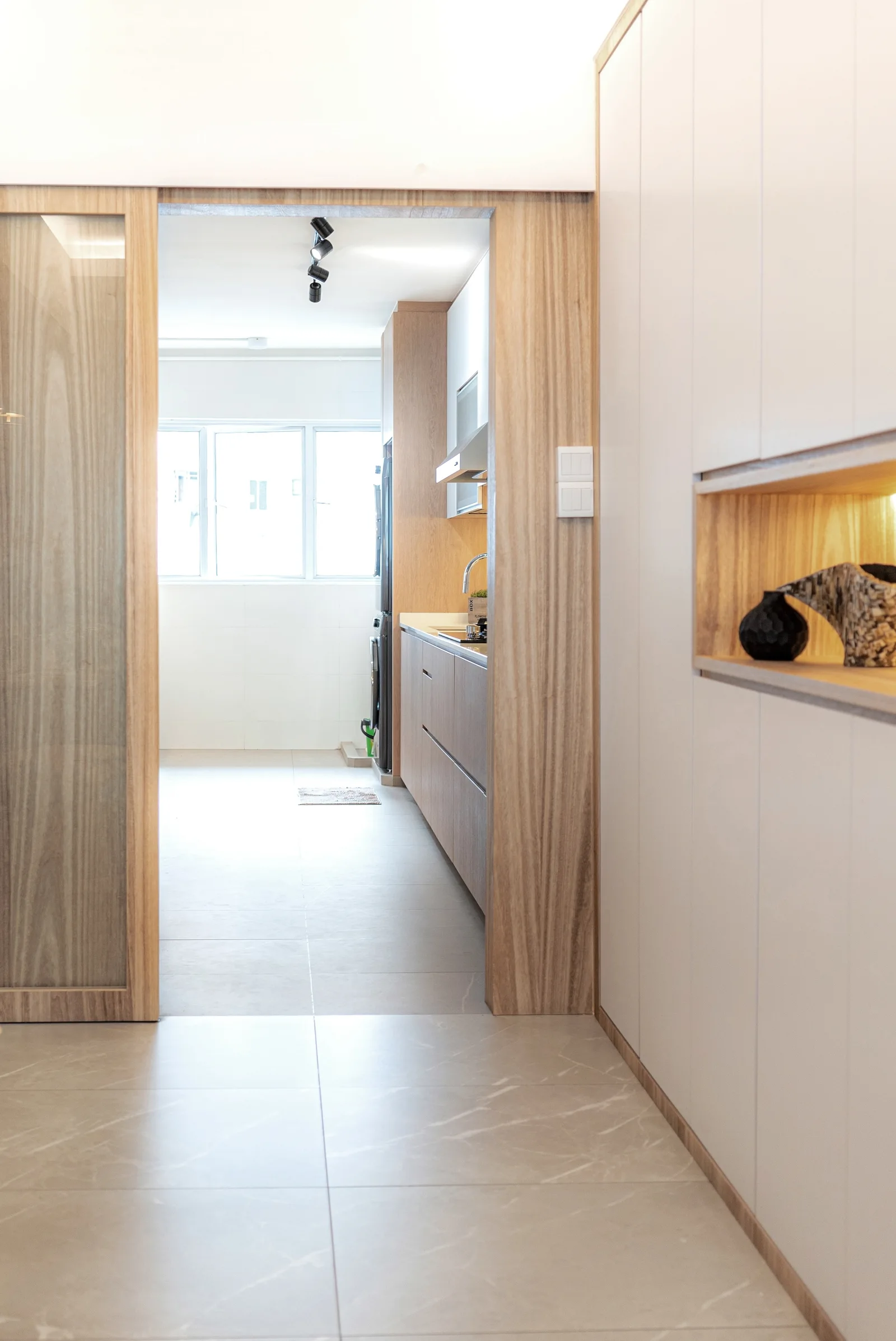 J Concept Designers &mdash; kitchen glass door framed in rich wood veneer with display niche glimpse