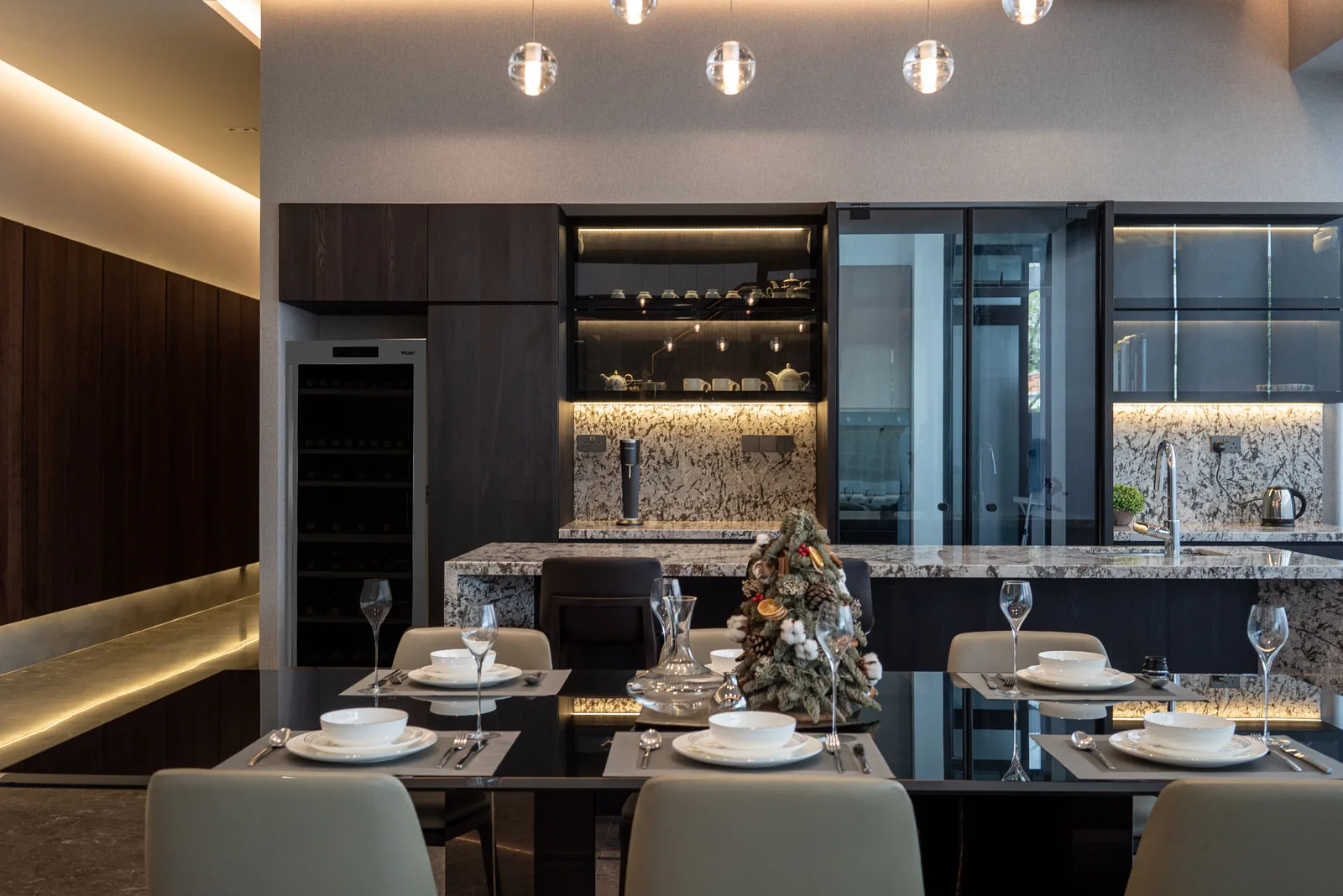 J Concept Designers &mdash; dining and dry kitchen evening view with stone splashback and cabinetry