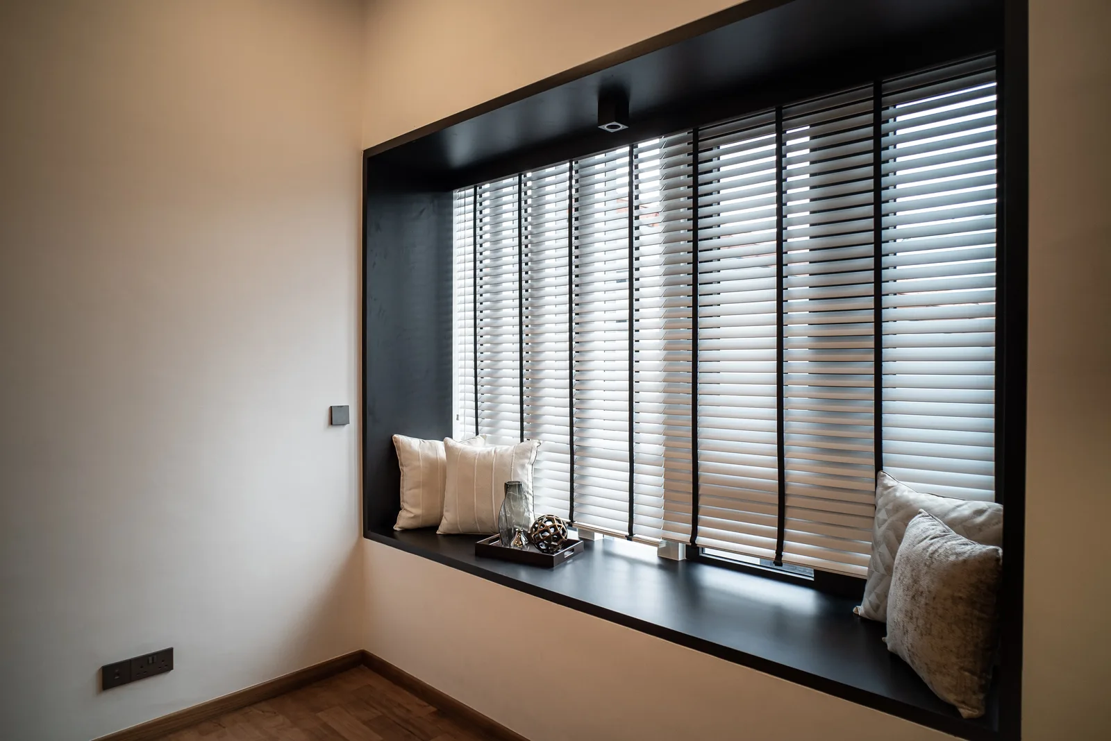 J Concept Designers &mdash; black-framed window seat with timber blinds in bedroom
