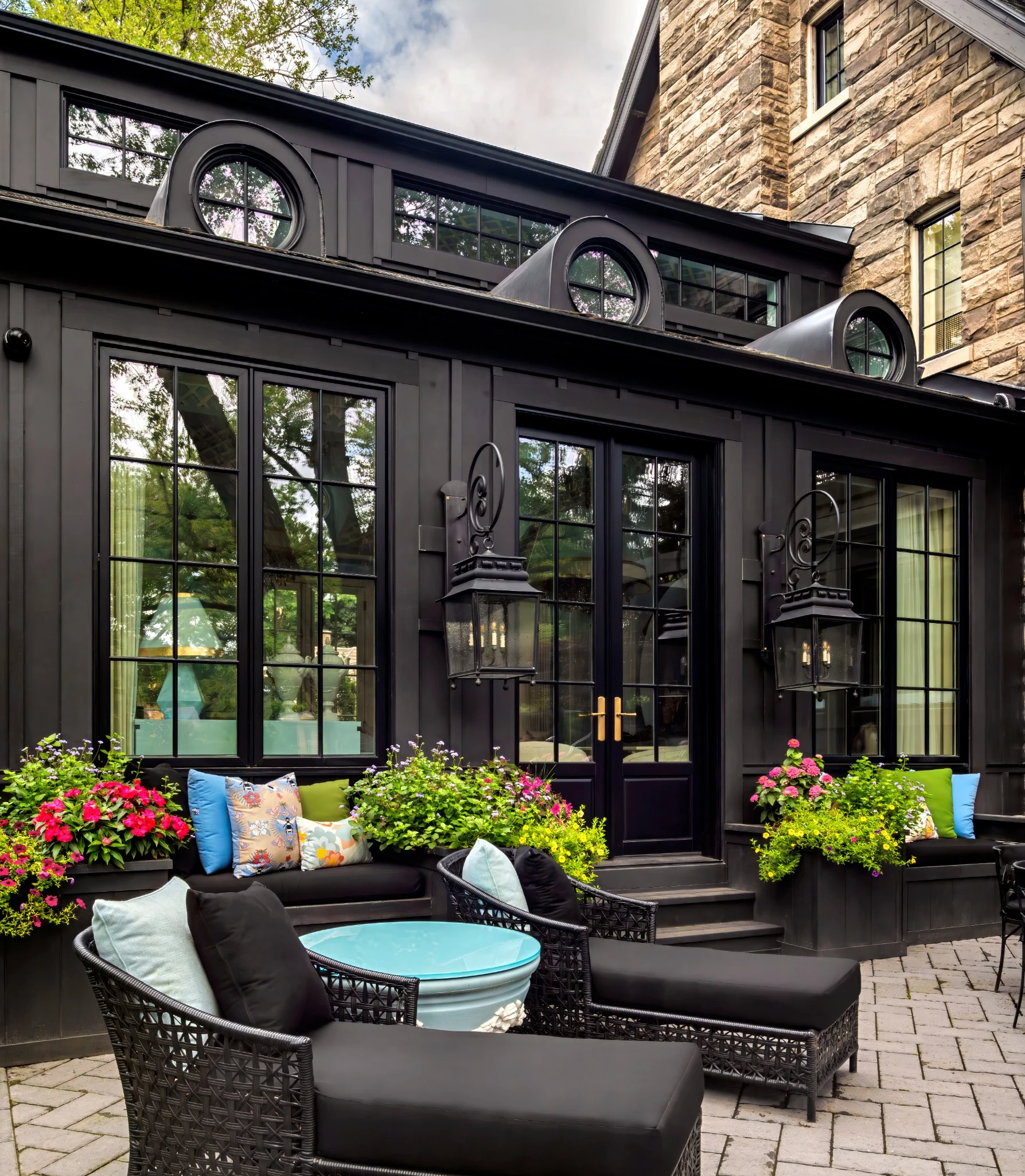 Lori Morris Design &mdash; private garden terrace with black woven furniture, colourful cushions and abundant flowers