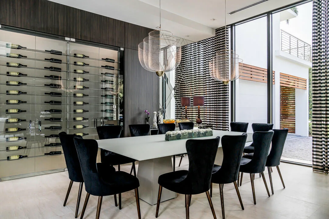 Guimar Urbina Interiors &mdash; Mid-century velvet chairs with wine collection
