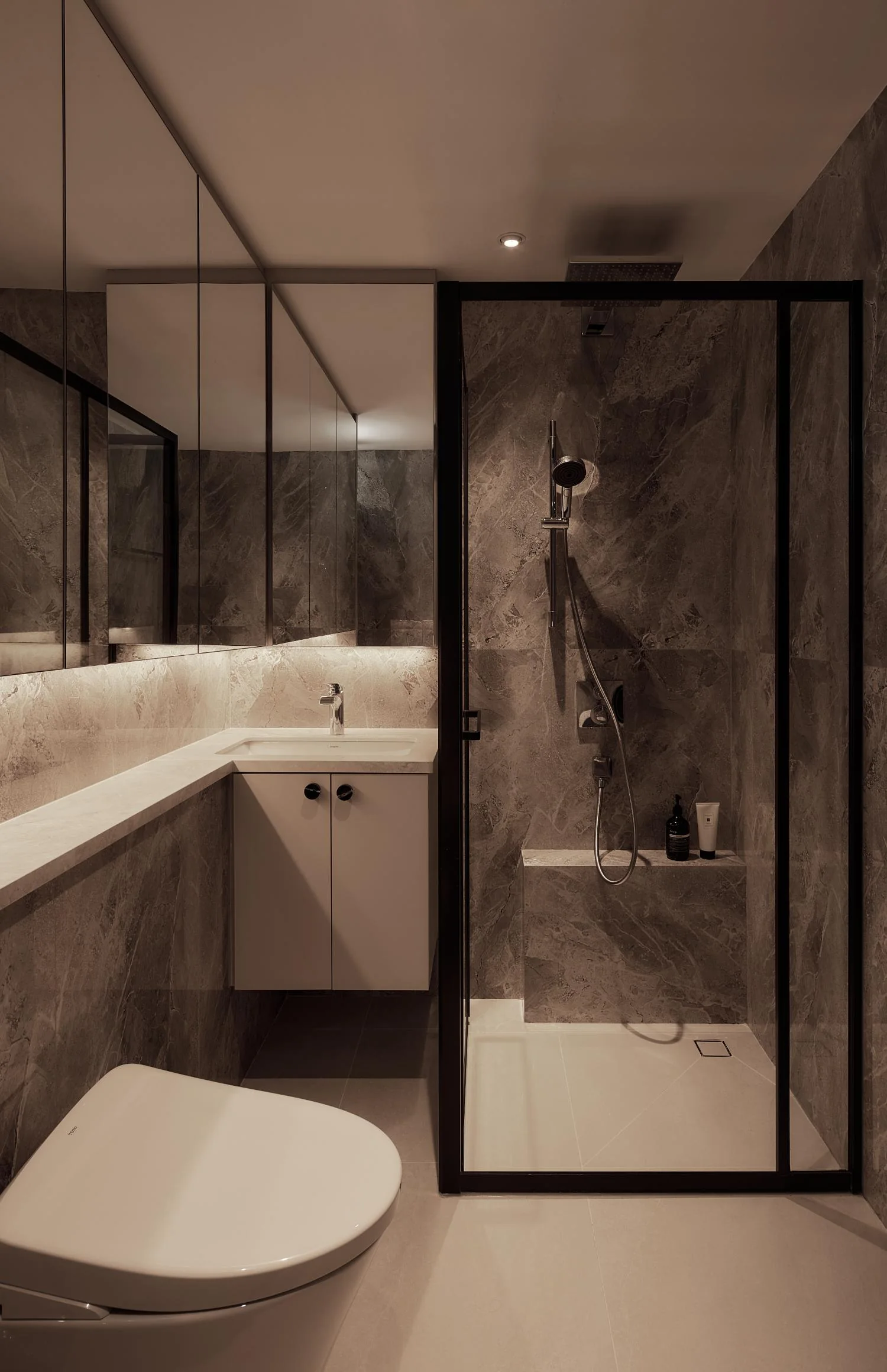 Master bathroom with glass shower enclosure at Esparina Residences