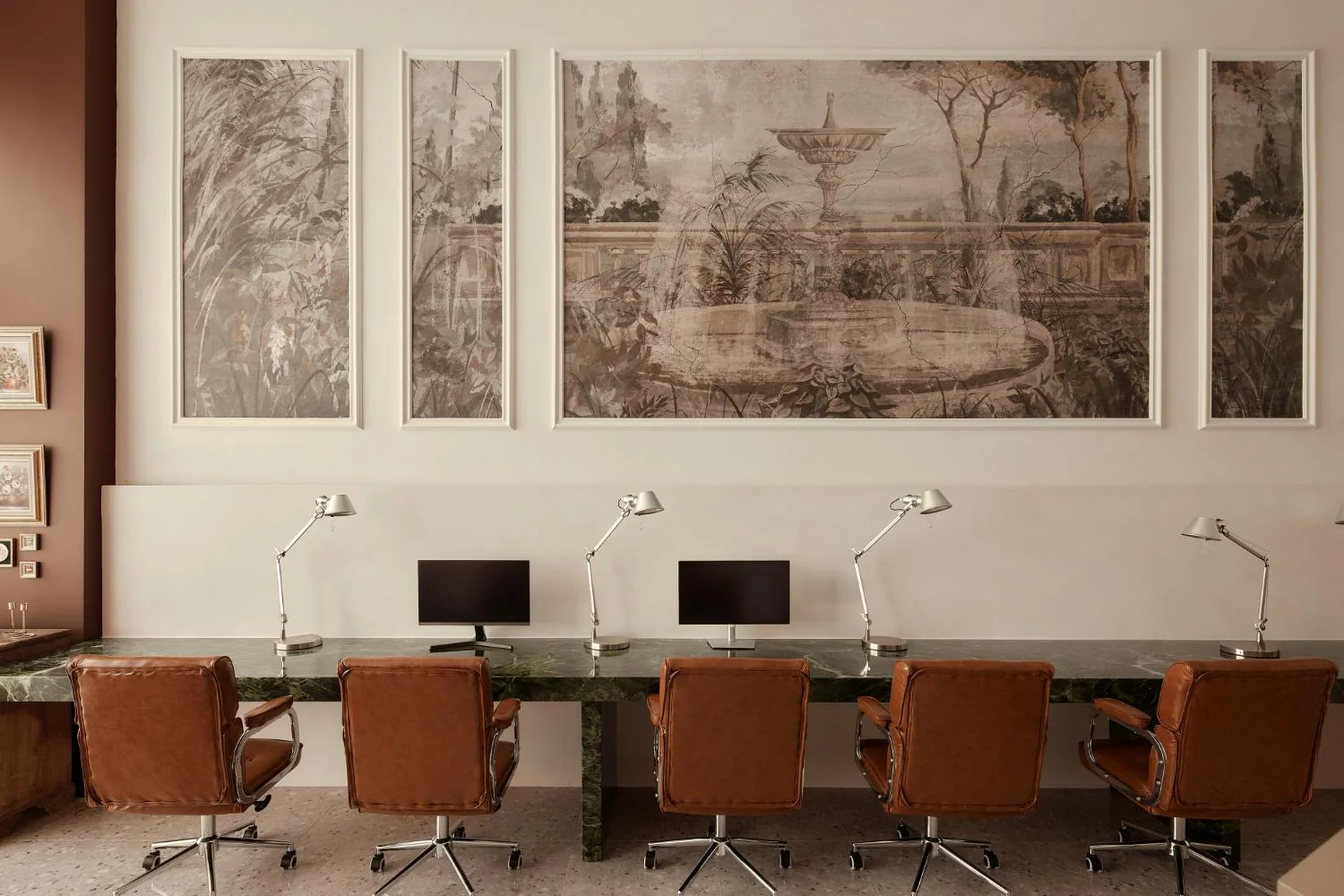 Shared RENOSTUD.IO workspace with Prada green marble desk, leather chairs and framed garden artwork