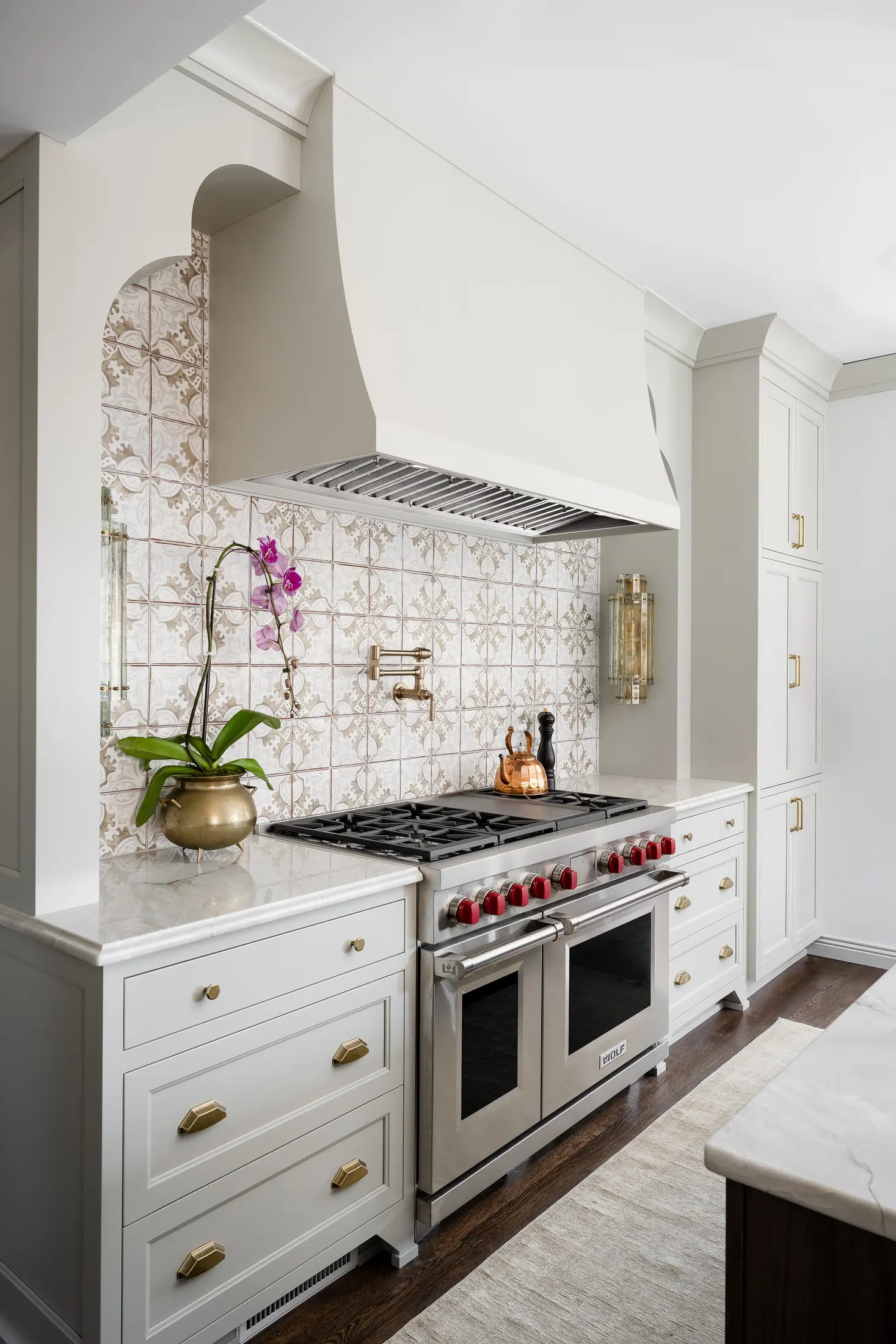 Wolf Dual Fuel Range with signature red knobs in a white kitchen